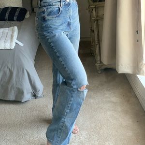 Medium wash, wide leg denim, with ripped knee.
